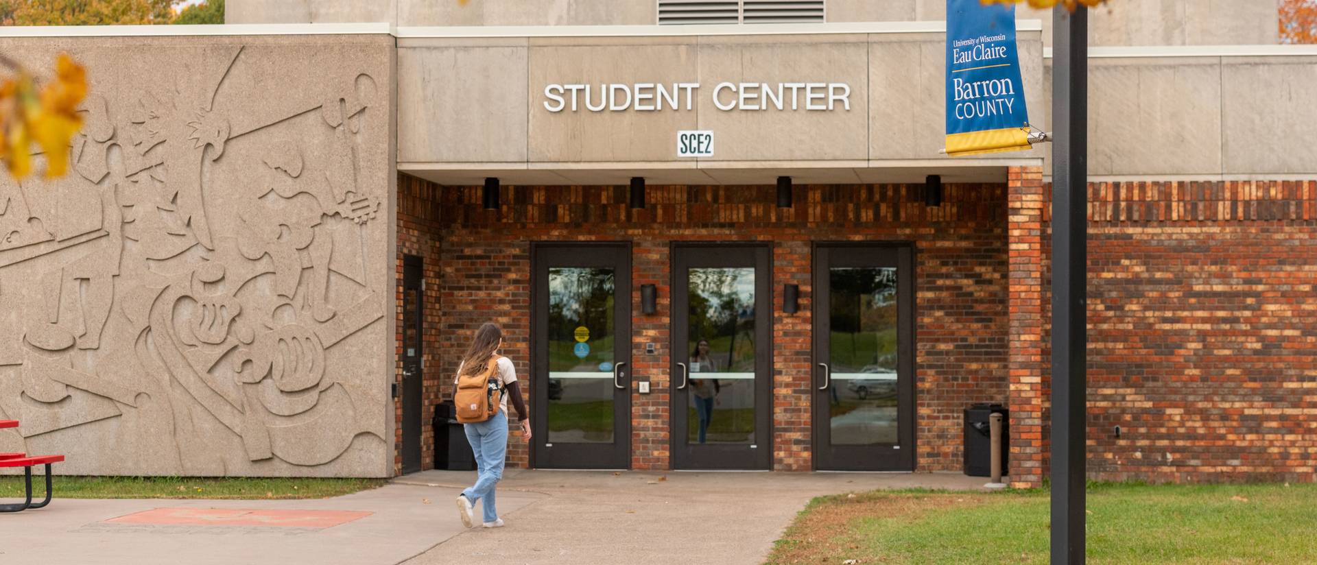 Student walking into UW-Eau Claire – Barron County student center