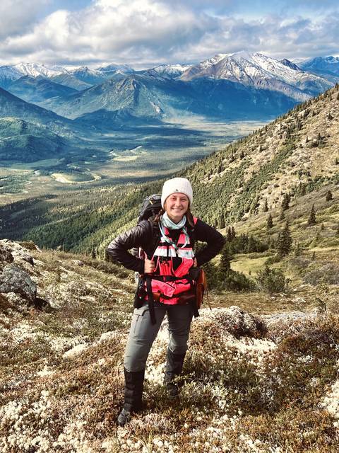 Bryanna poses on a mountainside in Alaska.