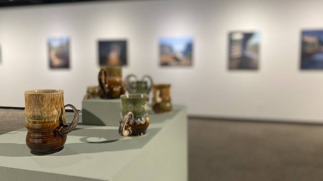 Installation view of the foster gallery showing ceramic work in the foreground and paintings in the background