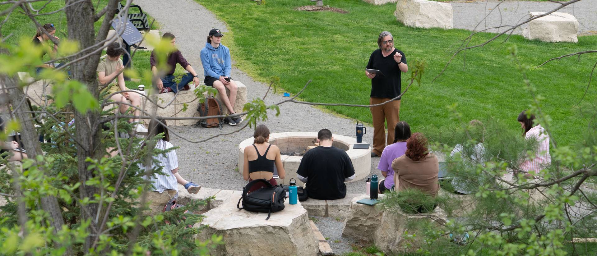 a class of students and faculty member who moved outside for a spring session