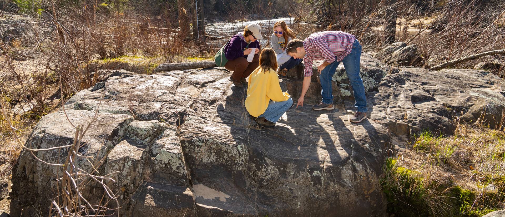 geology class out on river boulders with Dr. Robert Lodge