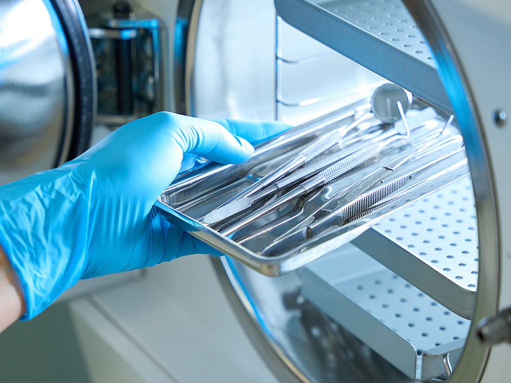 A medical professional sterilizing medical tools.