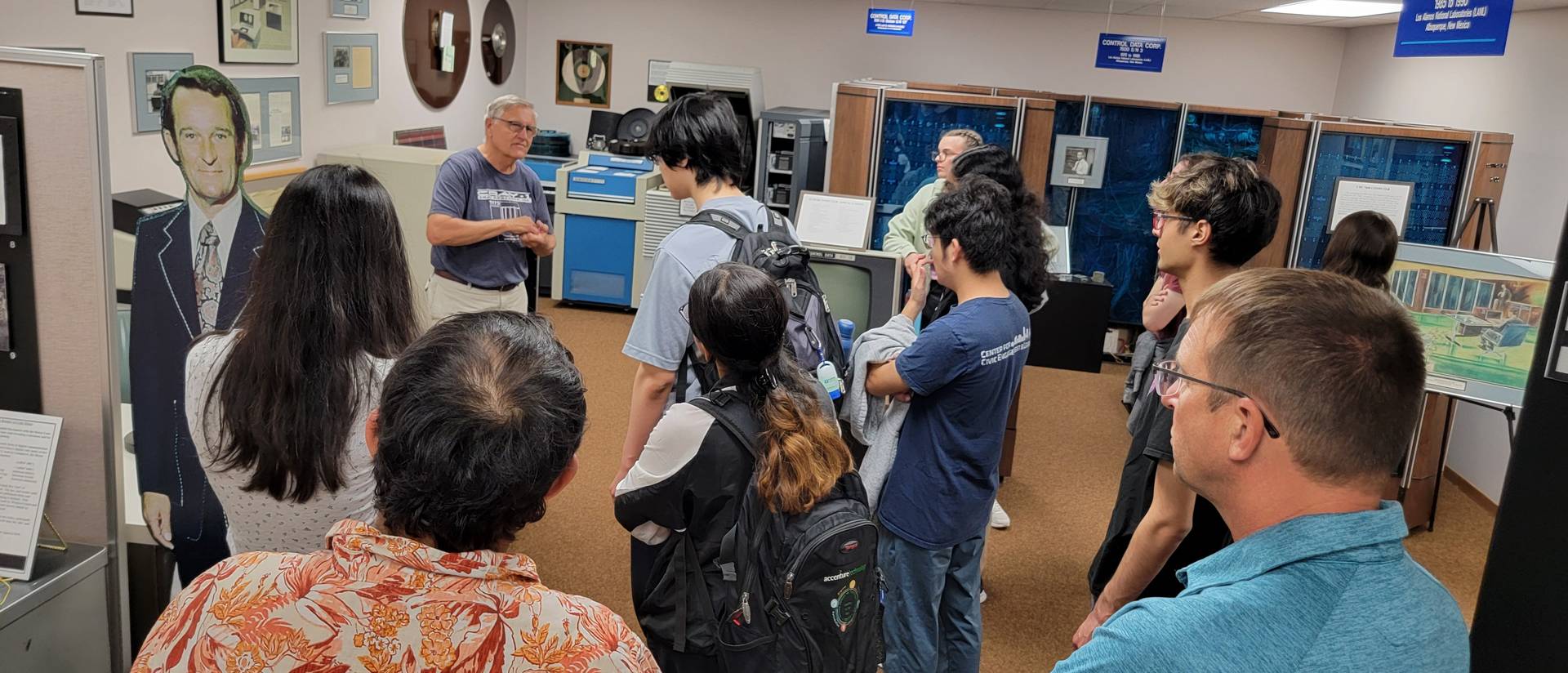 Summer 2025 REU students at the Chippewa Falls Museum of Industry and Technology learning from a retired Cray engineer