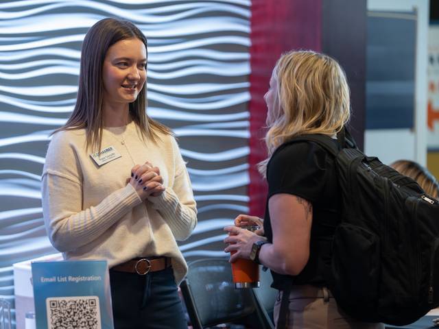 Hope Turvaville talking with a student at a January 2026 Chamber event hosted in Davies Center.