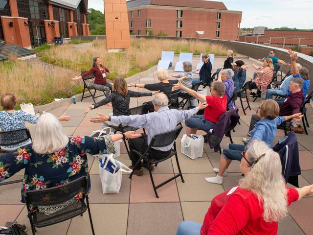 A presenter teaching chair yoga at the Academy for Lifelong Learners