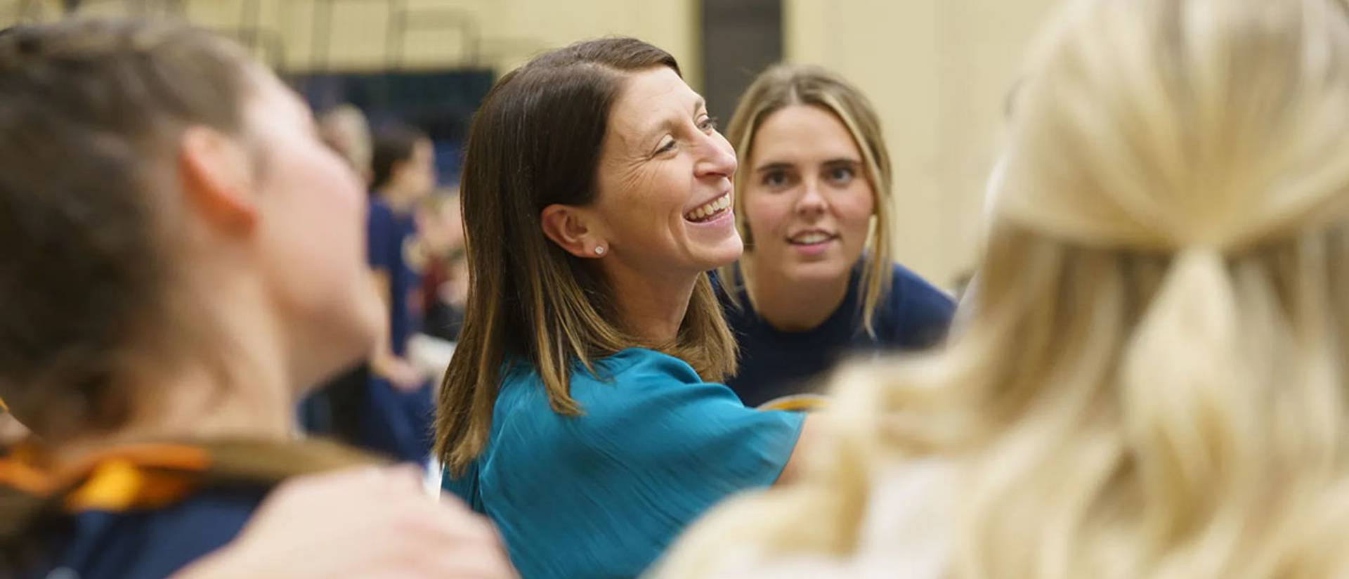 Kim Wudi smiles with her players nearby