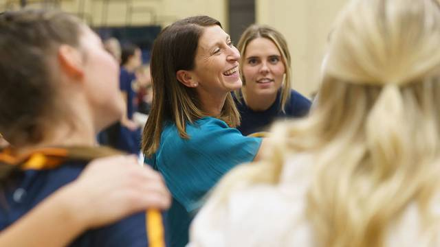 Kim Wudi smiles with her players nearby