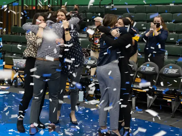 UW-Eau Claire volleyball coaches celebrate winning the 2021 NCAA championship.