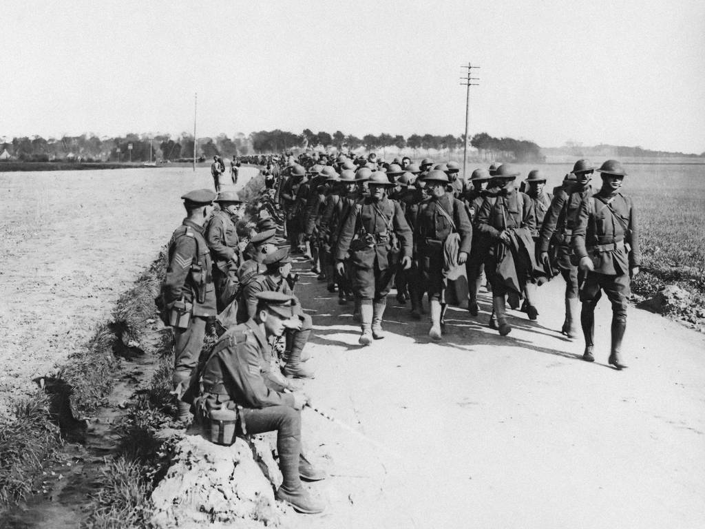 American troops in France passing British men resting by the roadside Columns of American troops marching along a road, France, during World War I.