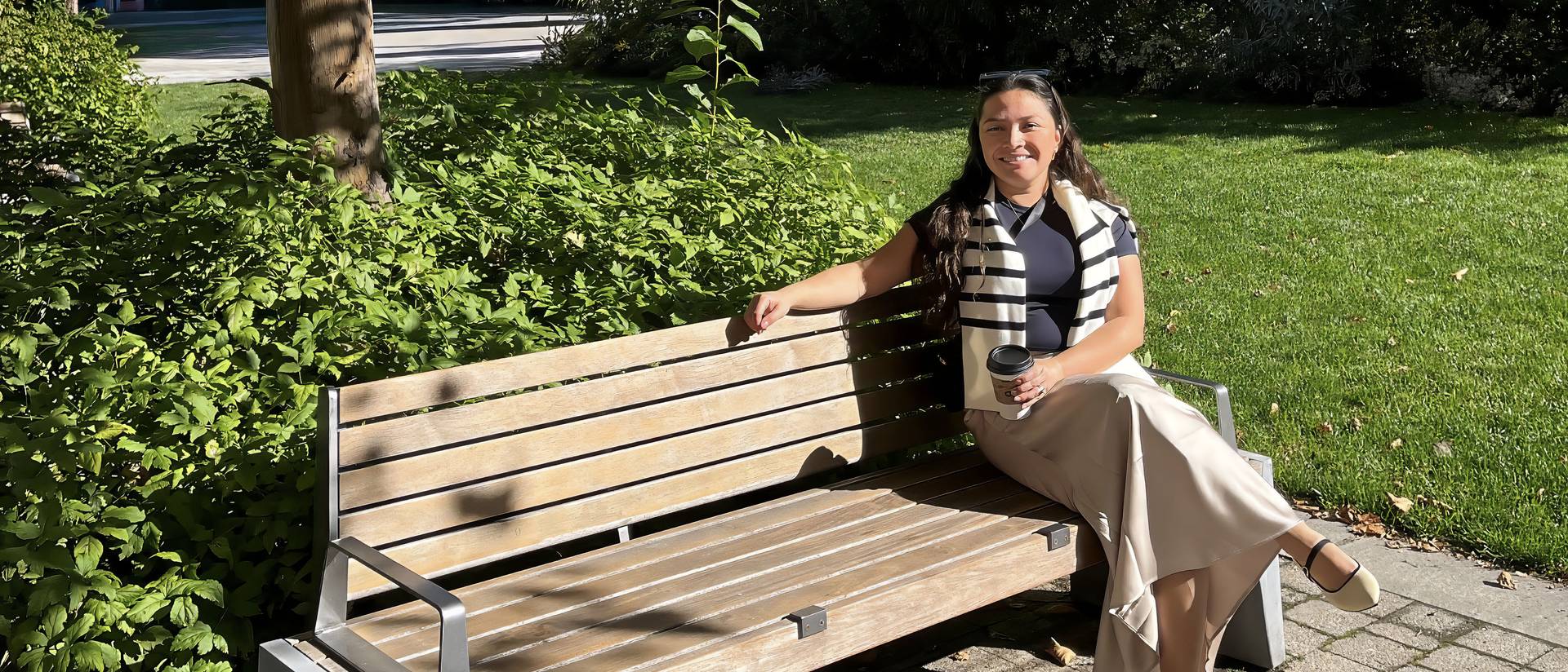 Helue Leslie-Vazquez sitting on a bench outdoors