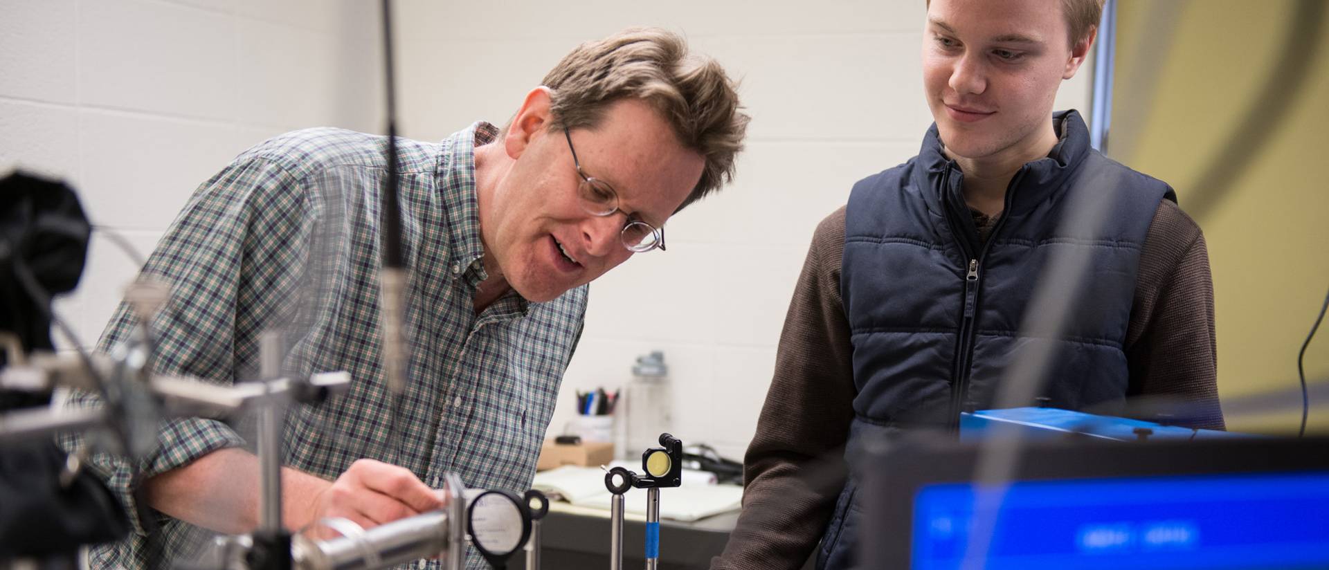 Dr. Stephen Drucker, UW-Eau Claire professor of chemistry, works on research related to photochemical reactions with student Michael McDonnell, Spring Valley.