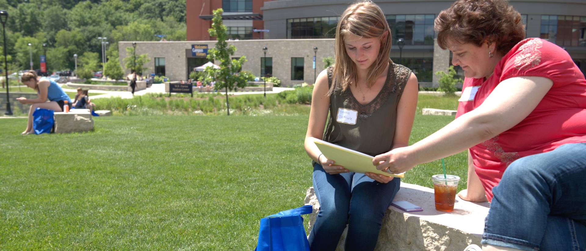 Parent looks on to academic information with her student.