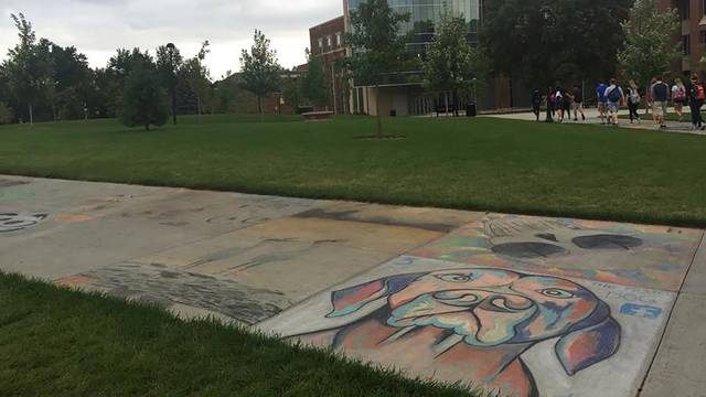 Chalk art on the sidewalks fades away after a week of rain.