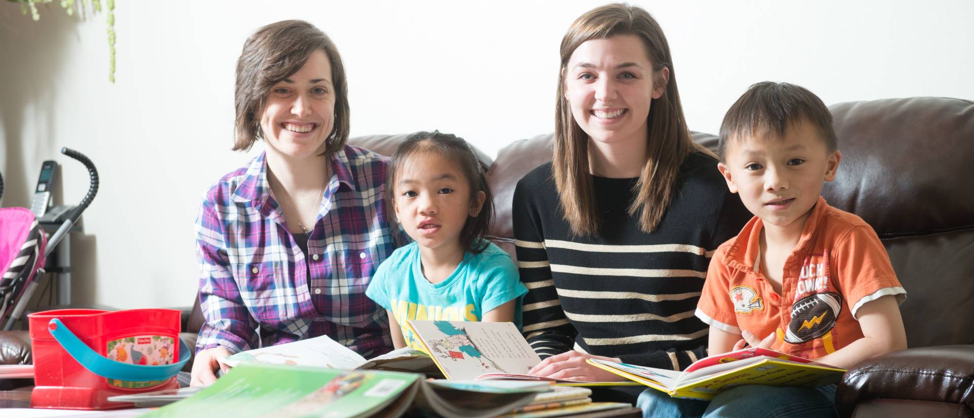 UW-Eau Claire students Jeannie LaFavor, left, and Shannon Harris, right, spend time with their reading partners.