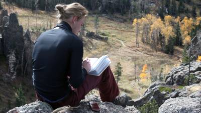 Person studying on rock