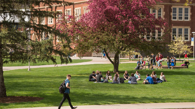 spring scene of students outside Schofield Hall