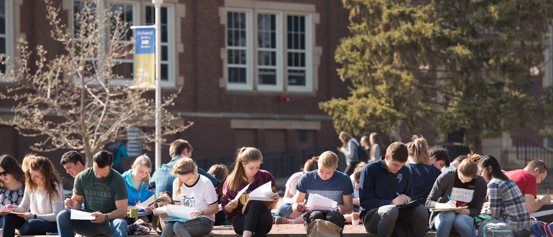 UW-Eau Claire students study in front of Schofield Hall.