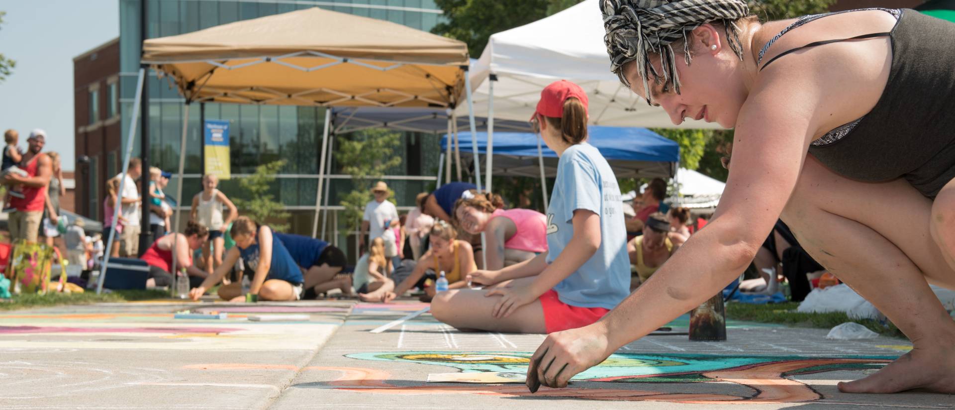 Artists decorate the Campus Mall sidewalk during Chalkfest 2015.