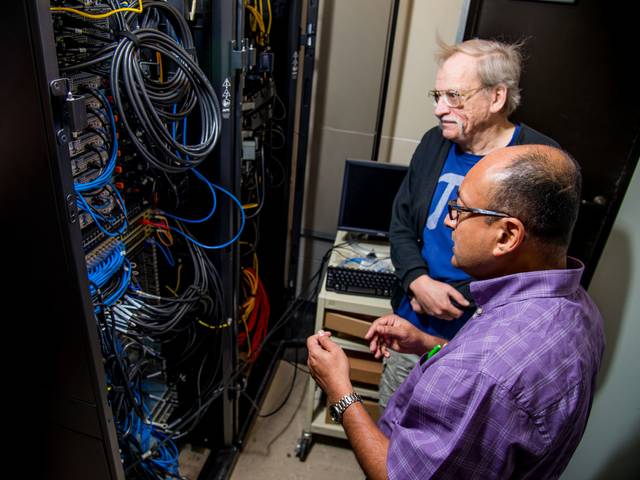 Dr. Bhattacharyay and Dr. King working on the supercomputer.