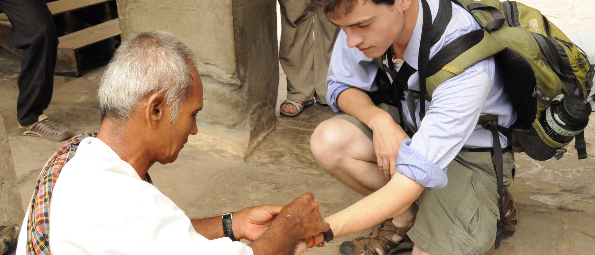 UW-Eau Claire student researcher interacting with Cambodian citizen