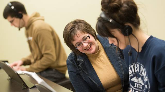 Professor Cruciani works with student on piano skills