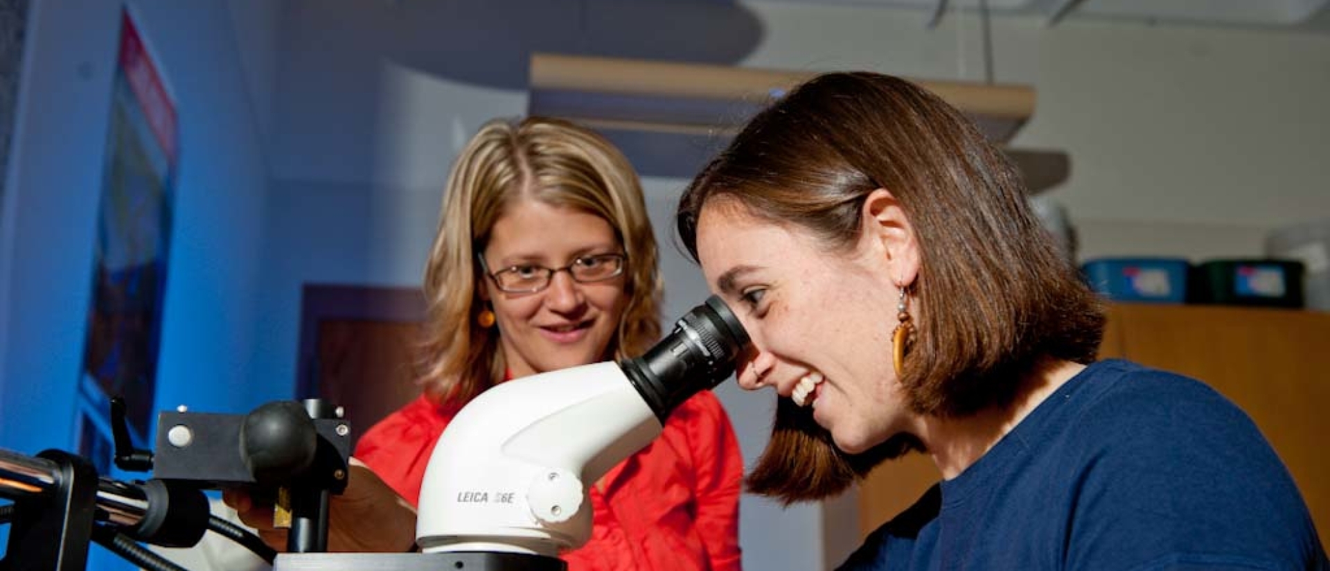 A student observes samples under a microscope.