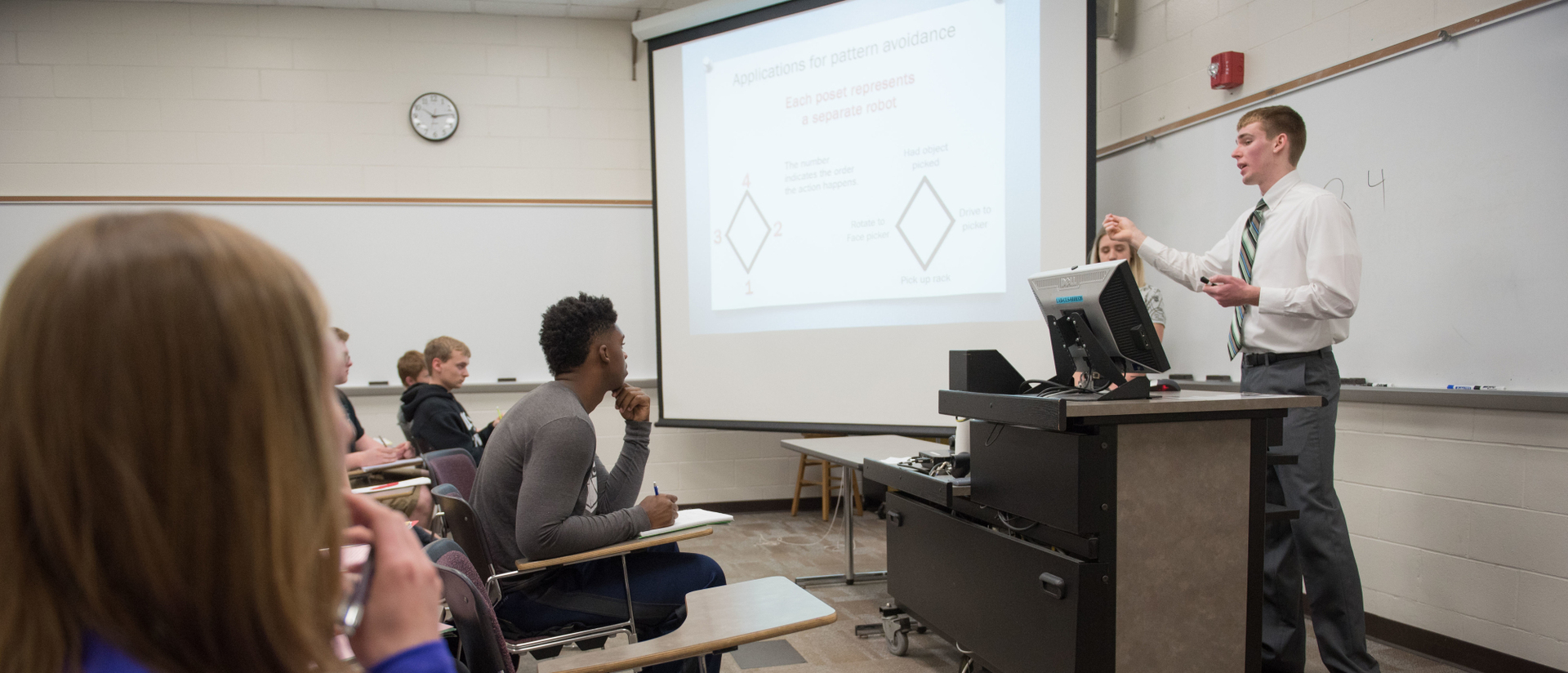 A math student leading a class.