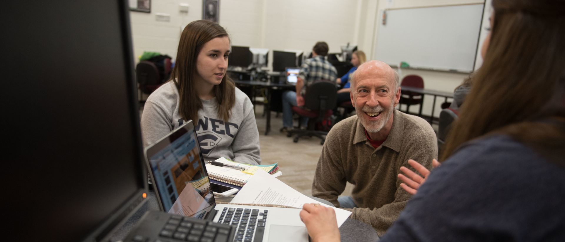 A professor working with students.