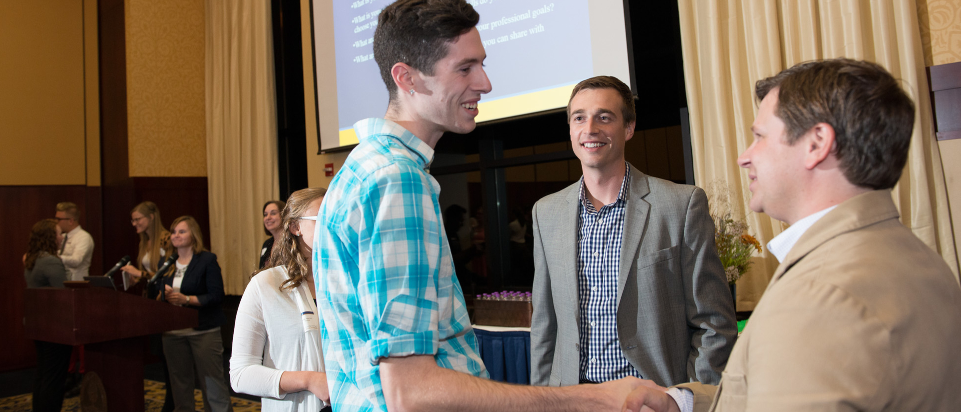 Student shaking hands at networking event