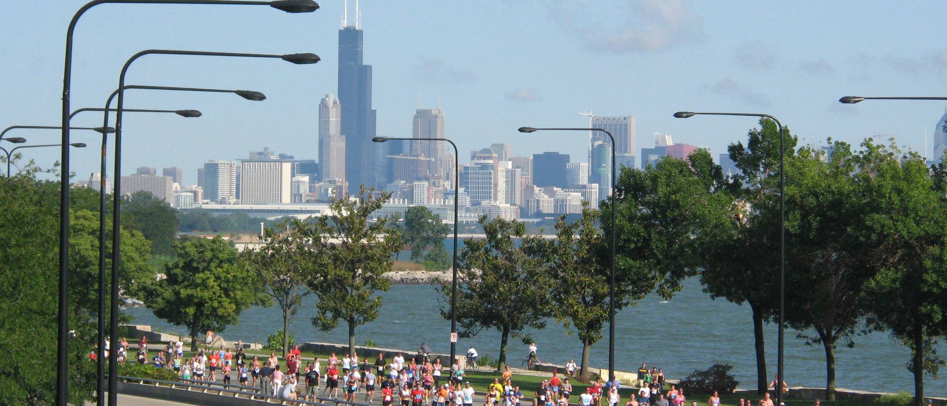 Participants race during the Chicago Marathon with the city skyline in the background.