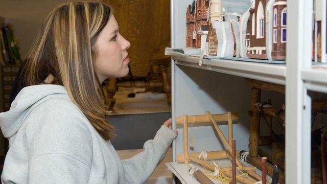 Student studies artifacts at a museum