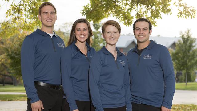 The UWEC Sales Team all smile as they pose for a group photo on the campus mall.
