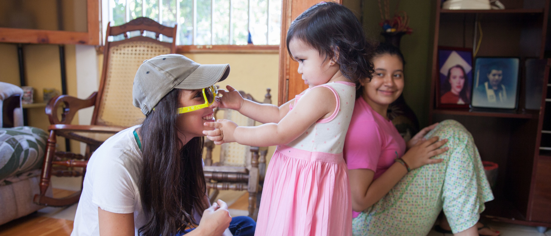 Student and little girl playing with sunglasses