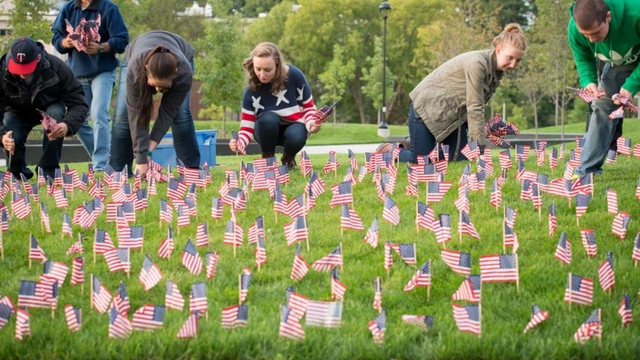 Students place U.S. flags on the UW-Eau Claire campus mall in honor of Veterans Day.