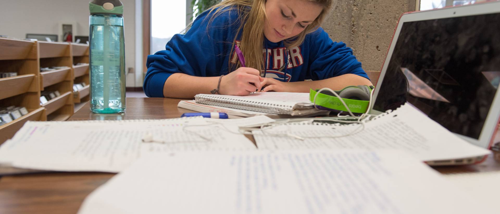 A student covers a desk with notes as the study during finals week.