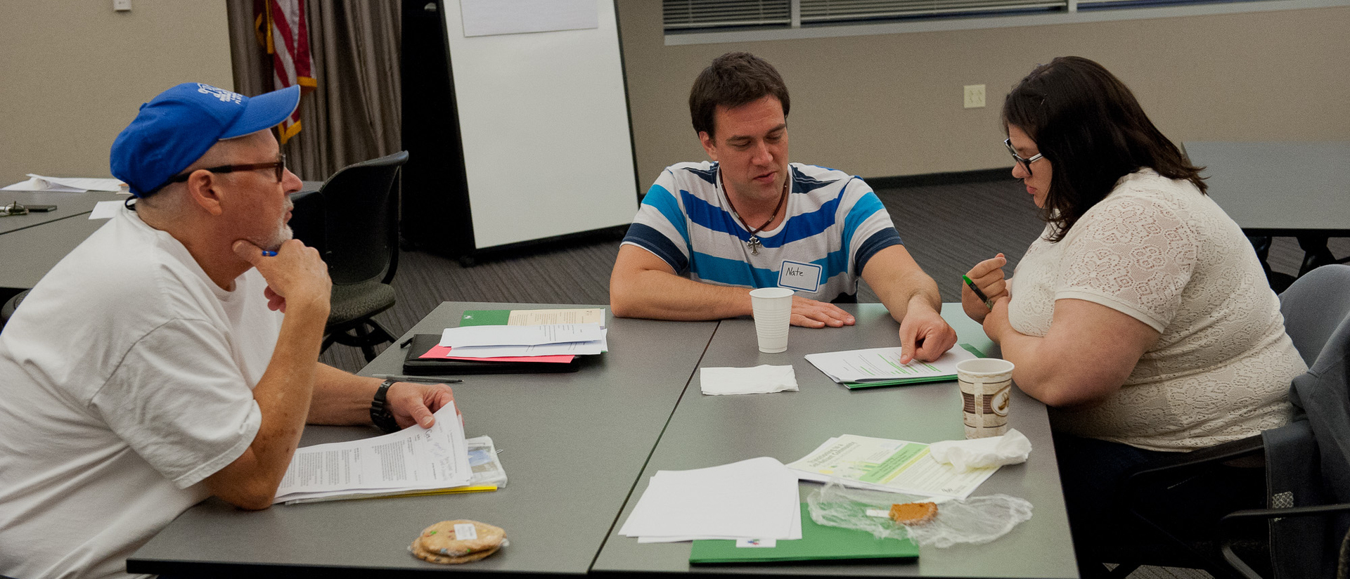 People at a table going through paperwork.