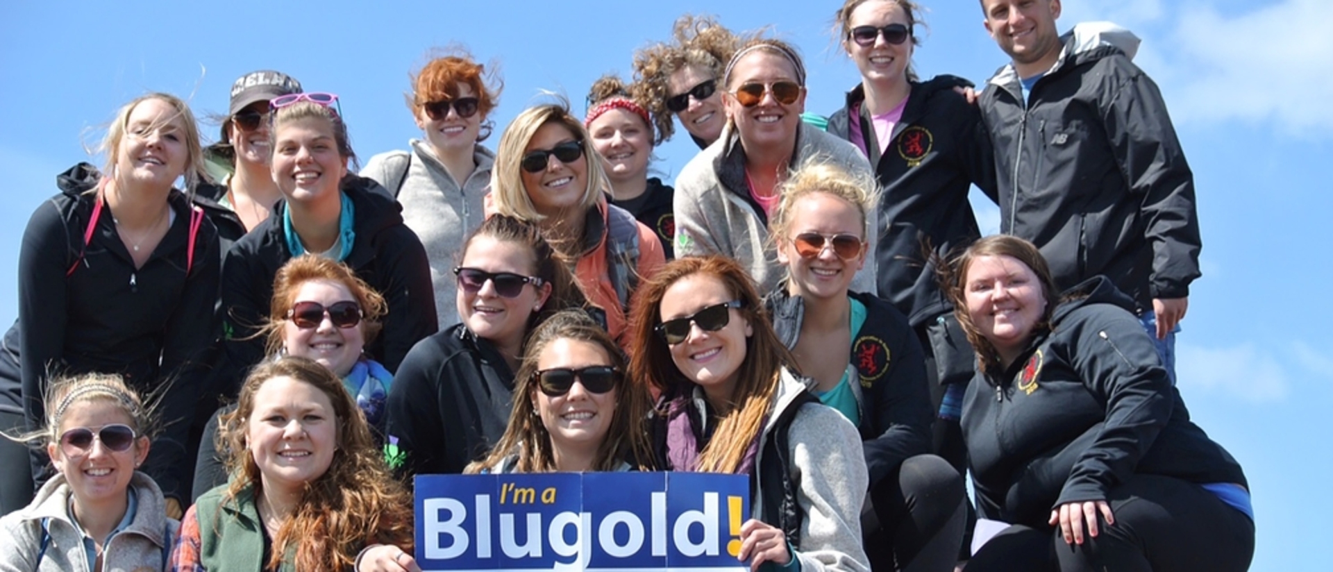 Students holding a Blugold sign
