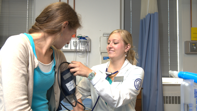 Nursing student practicing on a patient