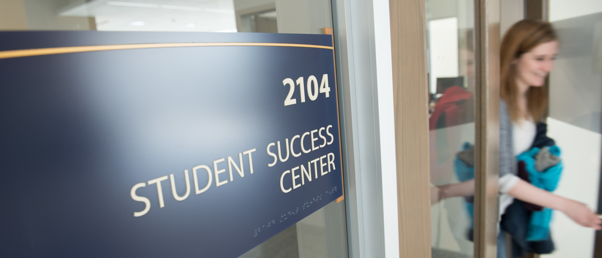 Student leaving the Student Success Center with a wonderful smile on her face