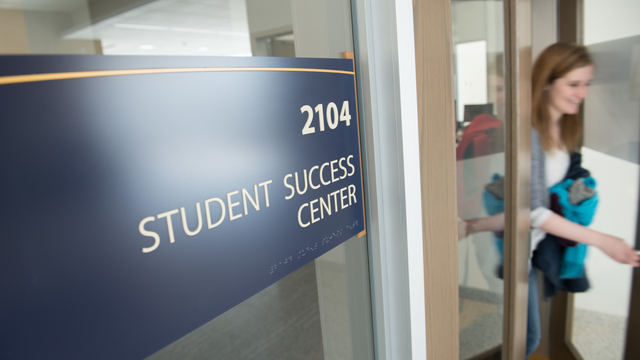 Student leaving the Student Success Center with a wonderful smile on her face