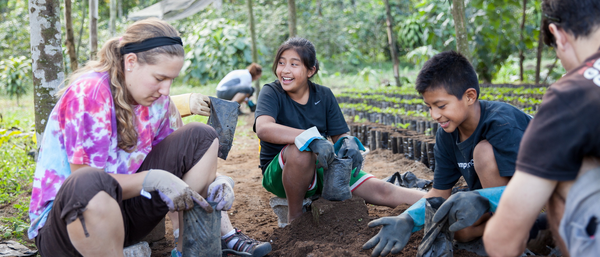 Student on immersion trip planting coffee in Guatemala