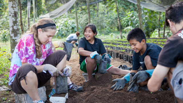 Student on immersion trip planting coffee in Guatemala