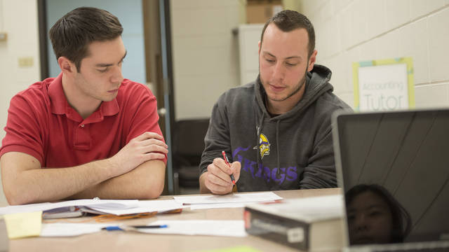 Business students receiving tutoring and academic support.