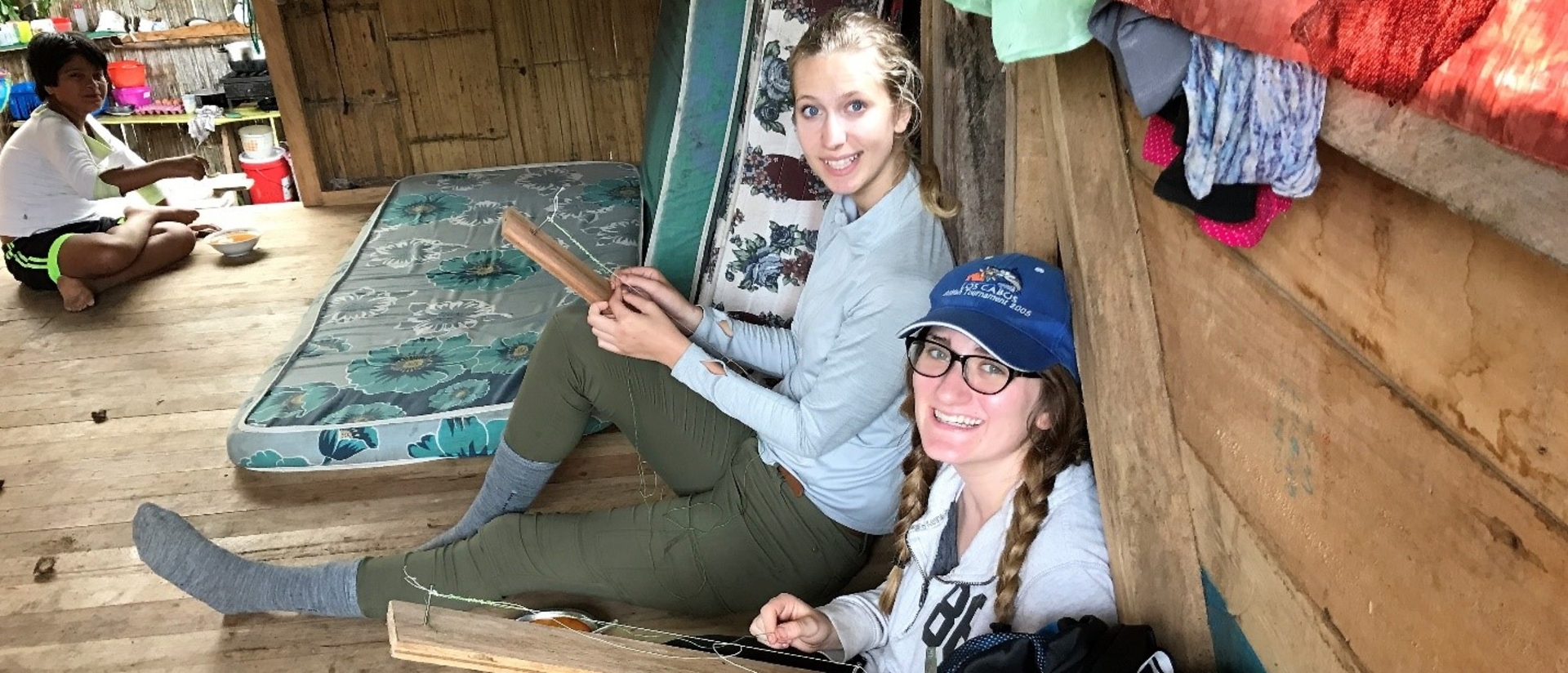 Blugold Hailey Nelson (right) and her host sister spent time at her host family’s home making necklaces during Nelson’s immersion program in Ecuador. The necklaces were for the traditional Kichwa dance that was held later that day.