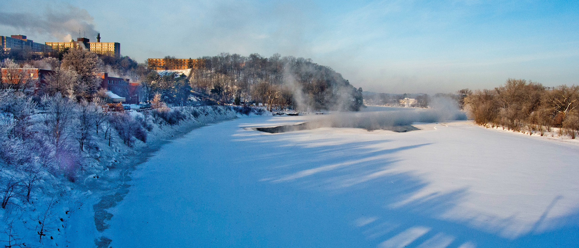 Chippewa River covered with snow and ice by the UW-Eau Claire campus.