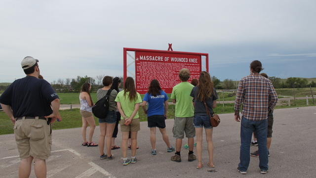 Students on the Pine Ridge immersion trip at the Wounded Knee Memorial