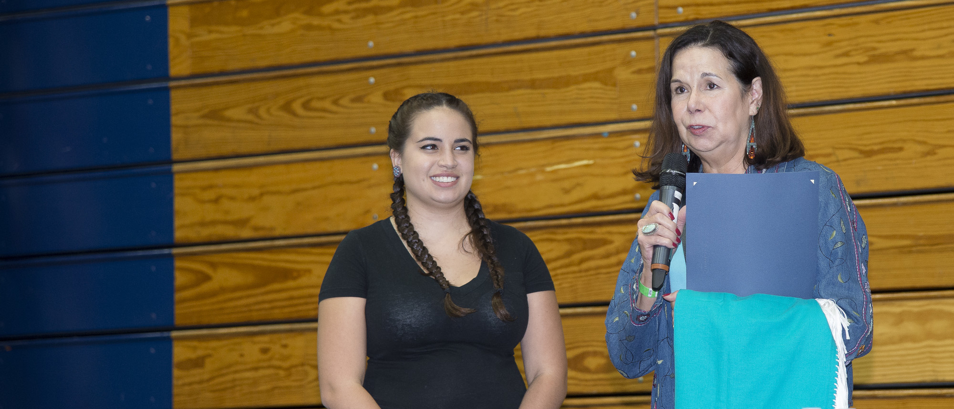 Student receiving a scholarship at the Honoring Education Powwow