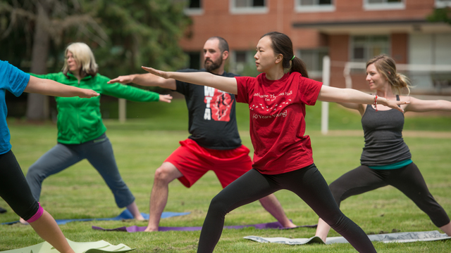 Students and faculty participating in a yoga class