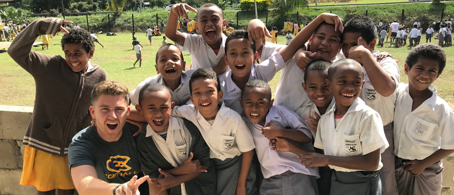 UWEC student poses with Fiji school children