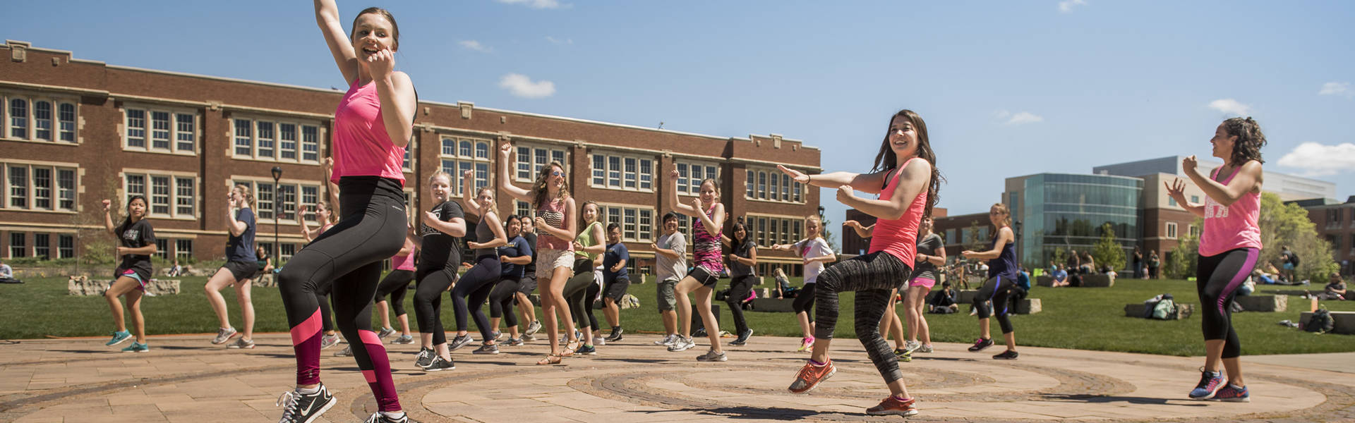 Students doing Zoomba at Spring Fest on campus mall. 